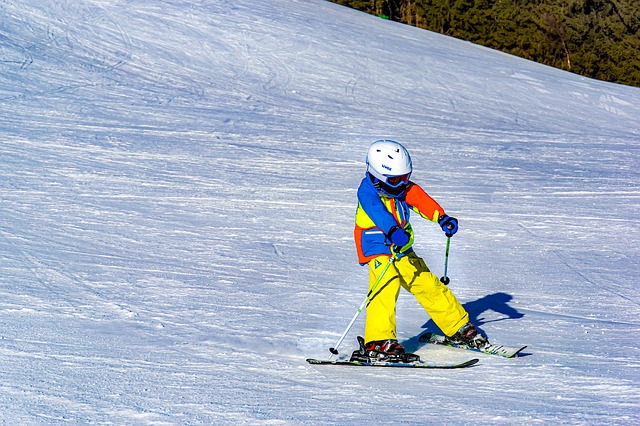 child snowplough skiing